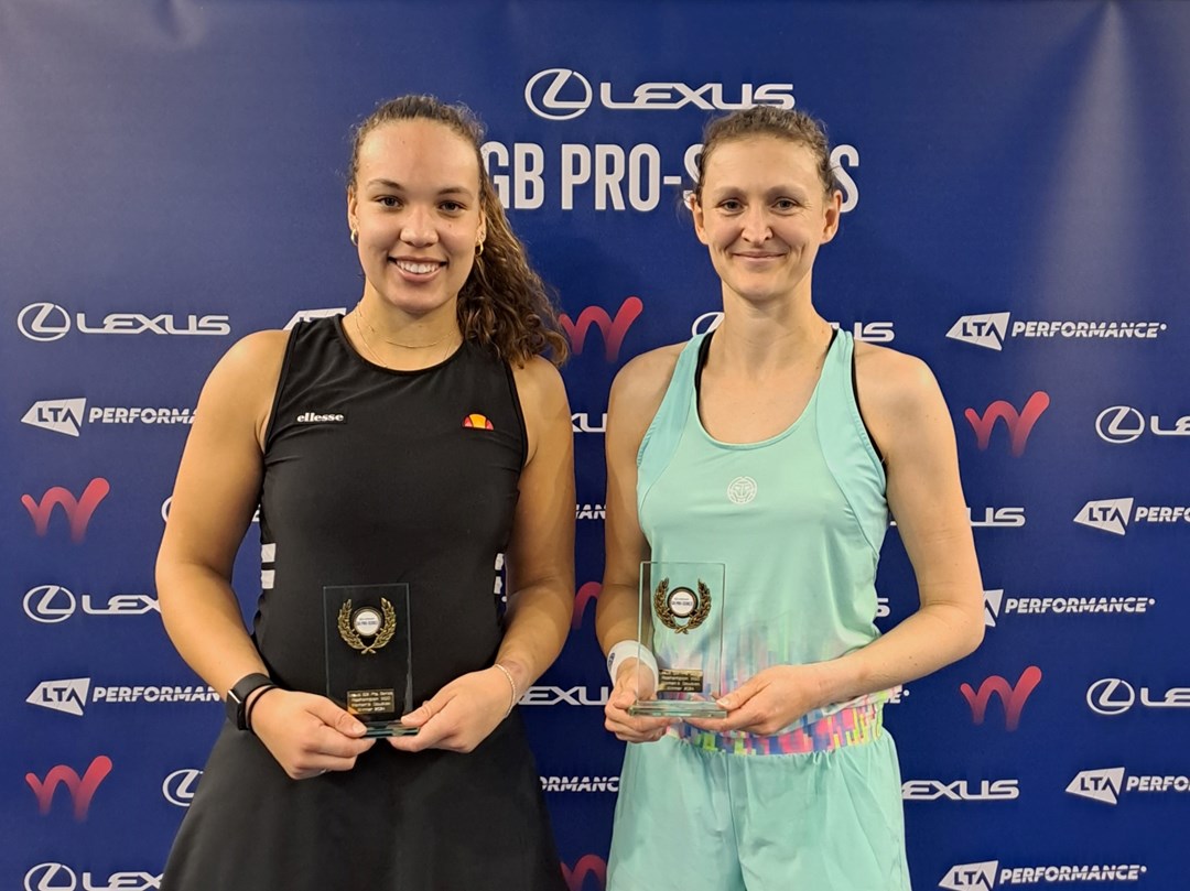 Freya Christie and Sam Murray Sharan holding their W50 Roehampton doubles titles on court