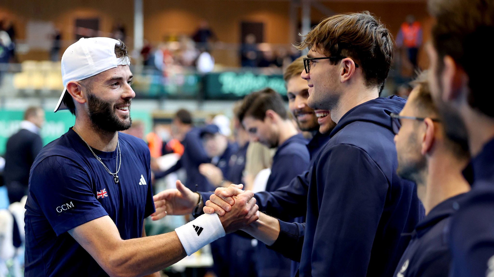 Jacob Fearnley celebrates his win over Nicolai Budkov Kjaer with the rest of the GB Davis Cup team