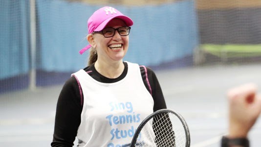 A woman on court taking part in the Tennis4RAd 10-week pilot course of tennis-based fitness classes.