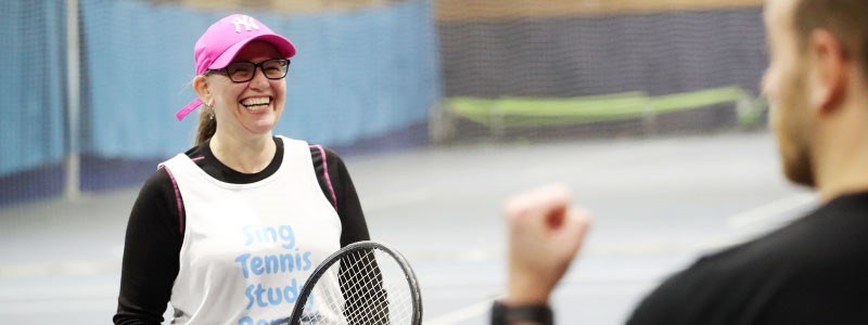 A woman on court taking part in the Tennis4RAd 10-week pilot course of tennis-based fitness classes.
