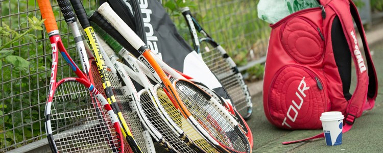 A collection of tennis rackets on a court