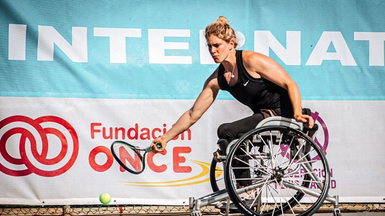 Robyn Love in wheelchair tennis action hitting a forehand
