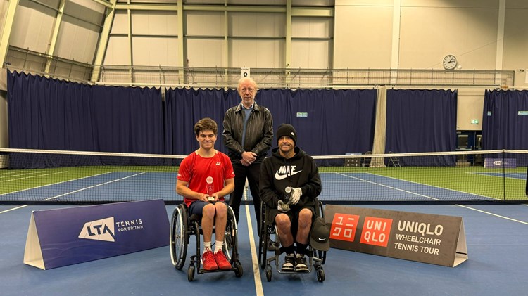 Greg Slade holding the doubles runner-up trophy at the Bolton Indoor ITF 2