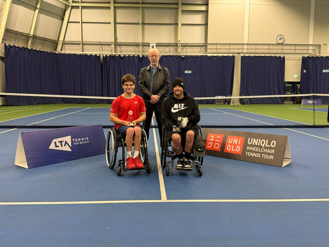 Greg Slade holding the doubles runner-up trophy at the Bolton Indoor ITF 2