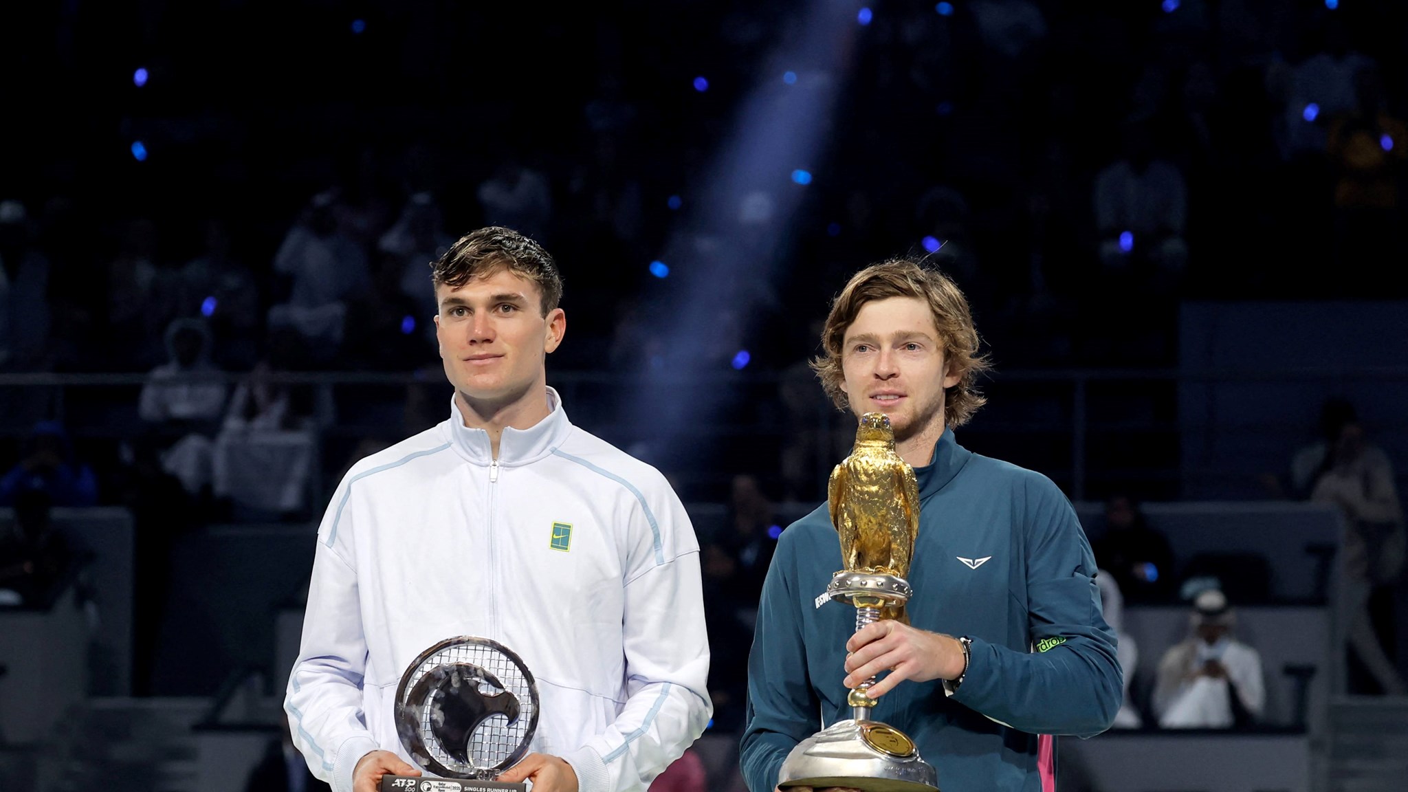 Jack Draper with the Qatar Open runner-up trophy next to champion Andrey Rublev 