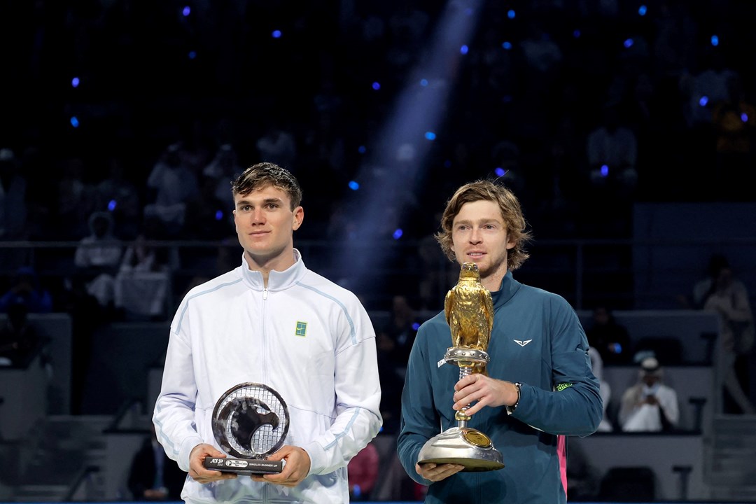 Jack Draper with the Qatar Open runner-up trophy next to champion Andrey Rublev 