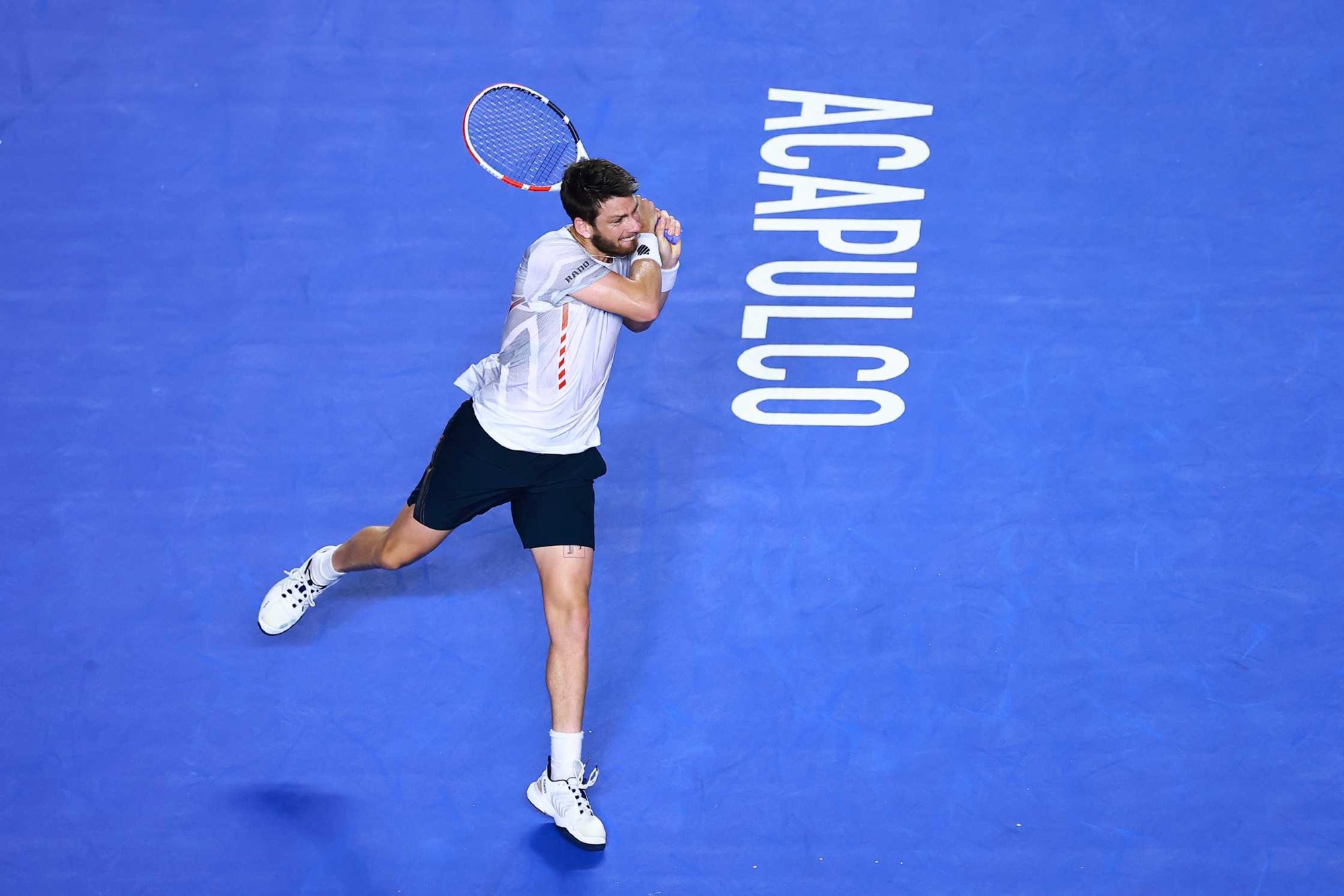 Cam Norrie hits a backhand against Stefanos Tsitsipas in Acapulco