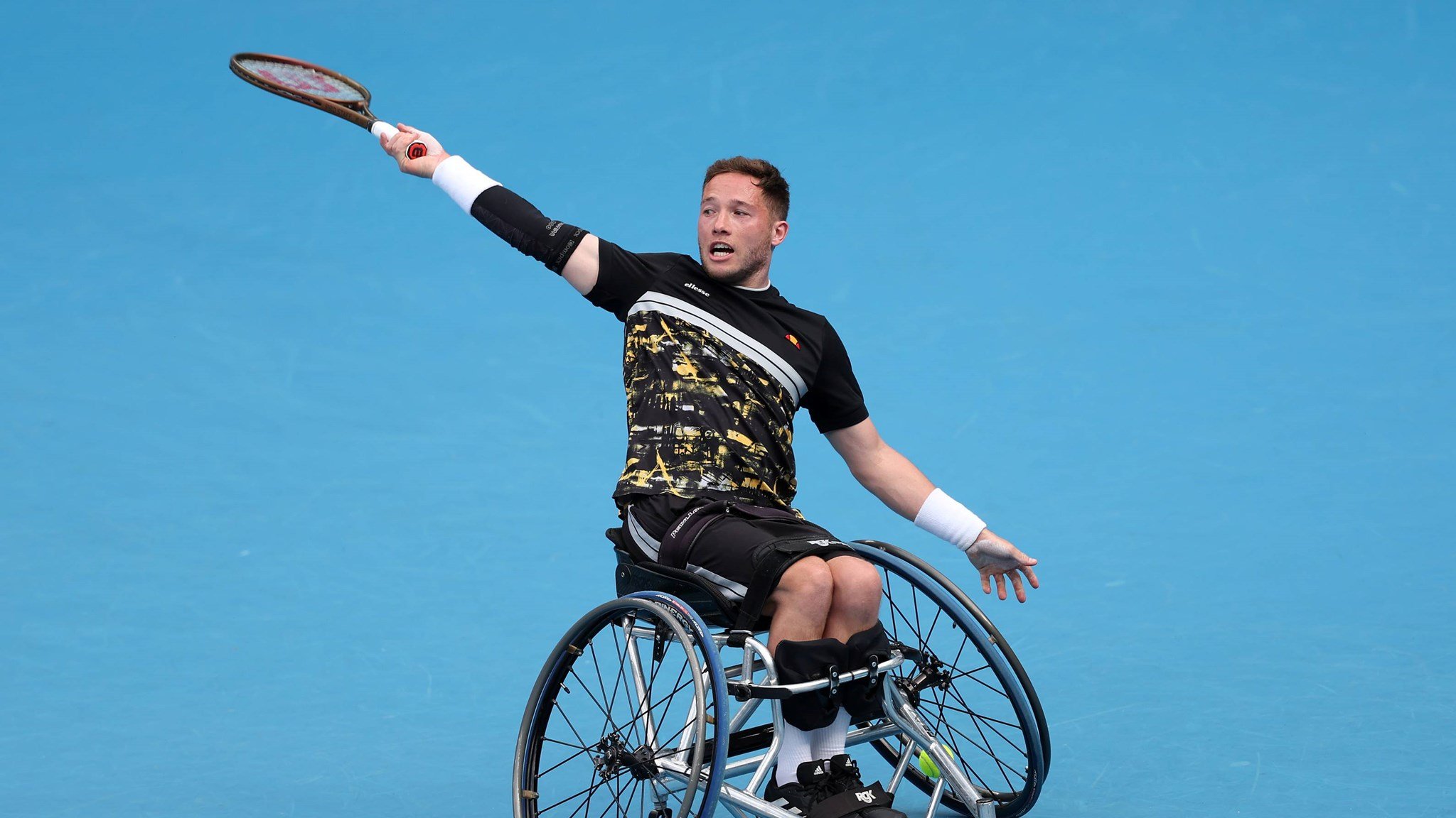 Great Britain's Alfie Hewett hitting a backhand on court in his wheelchair at the 2024 Australian Open