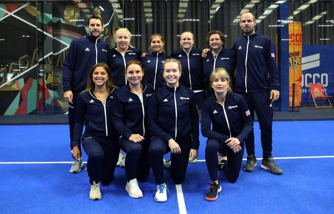 The GB womens padel team and coaches in two rows of 4 and 6. The back row are standing and the front row are on one knee.