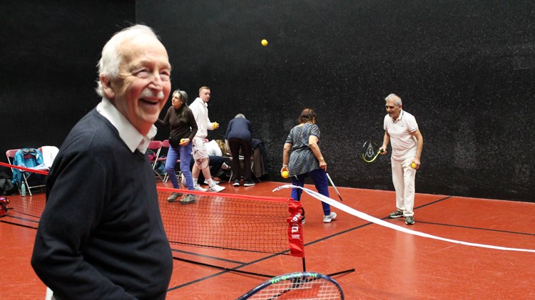 Seniors tennis players having fun on court at an inclusive session run by The Queen's Club Foundation