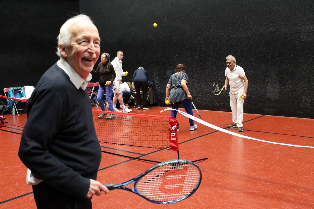 Seniors tennis players having fun on court at an inclusive session run by The Queen's Club Foundation