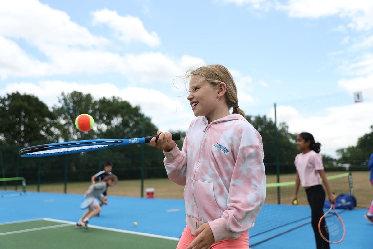 Girl holding racket and ball.jpg
