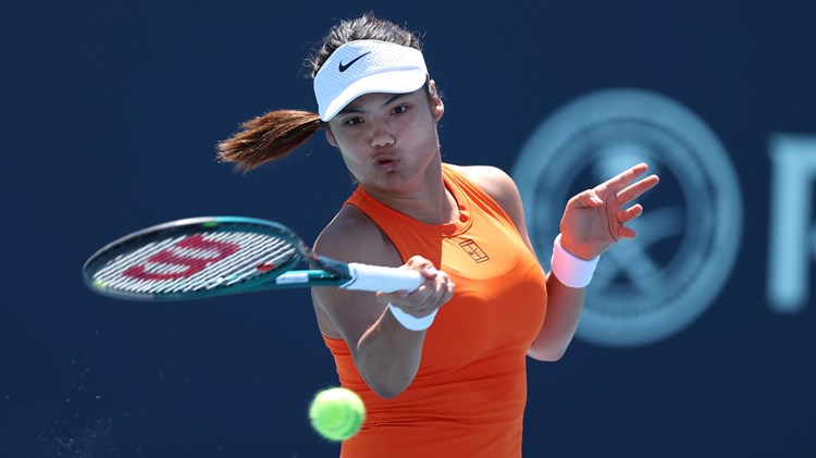 Emma Raducanu, wearing a Nike orange tennis top, hitting a forehand on court in the third round at the Miami Open