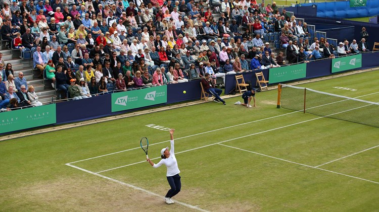 Player serving at the Ilkley Trophy in 2019