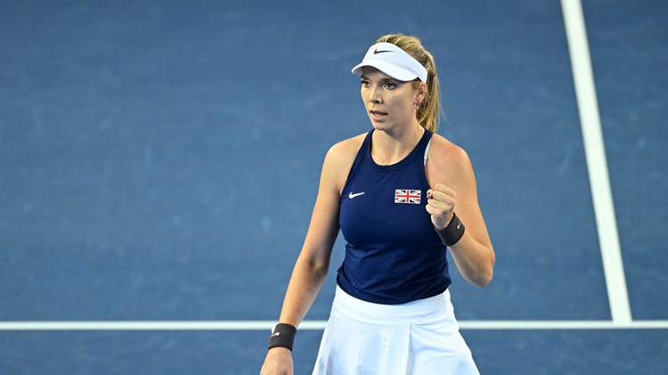 Katie Boulter stood on court at the Billie Jean King Cup wearing a navy top with a British flag on it