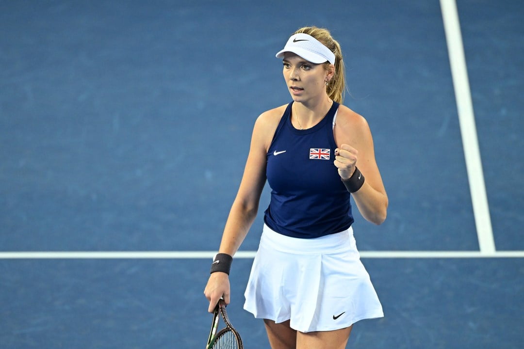 Katie Boulter stood on court at the Billie Jean King Cup wearing a navy top with a British flag on it
