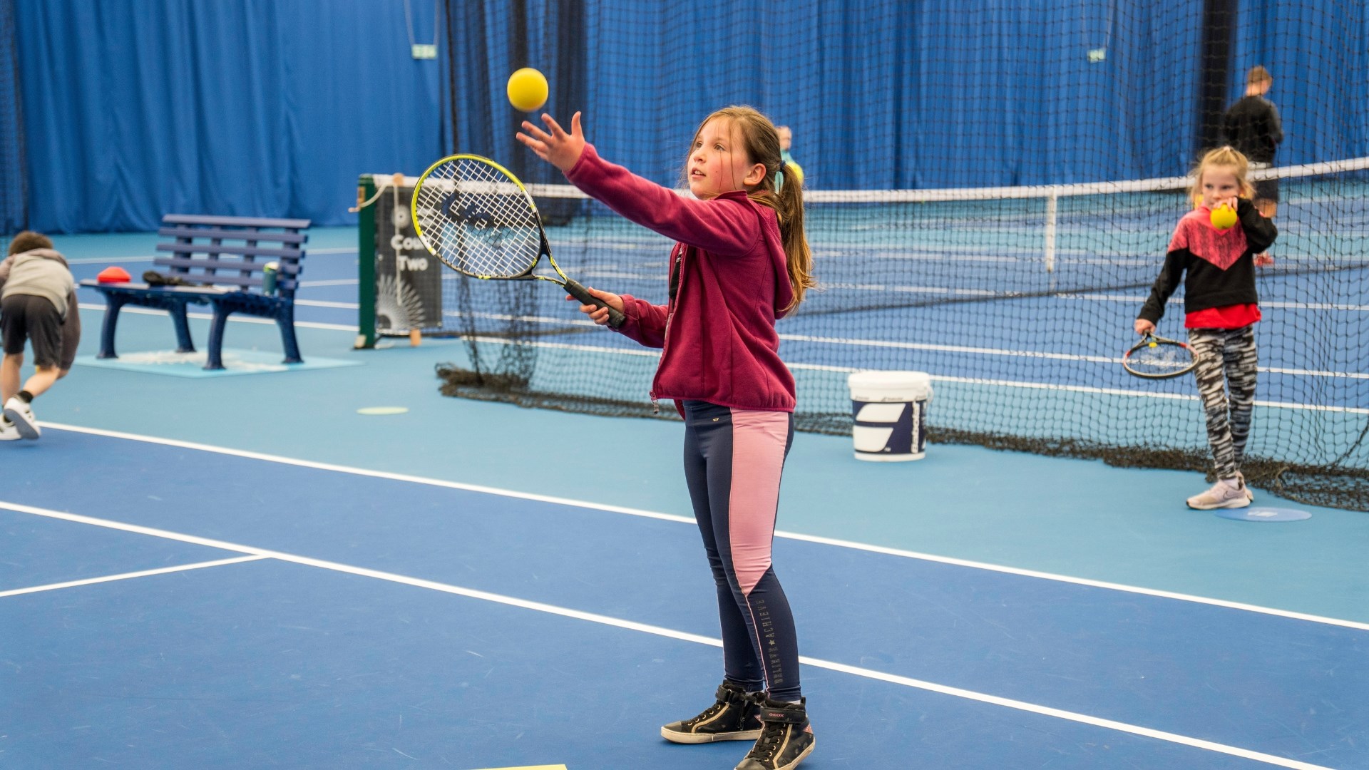 a young girl preparing to hit a sponge ball