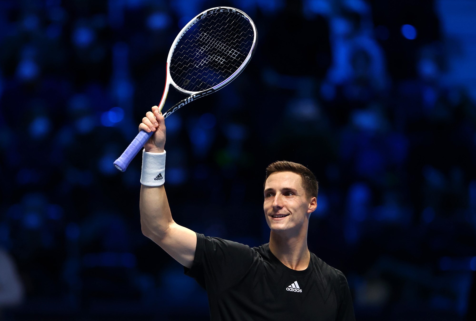 Joe Salisbury raises his racket in celebration at the 2021 Nitto ATP Finals