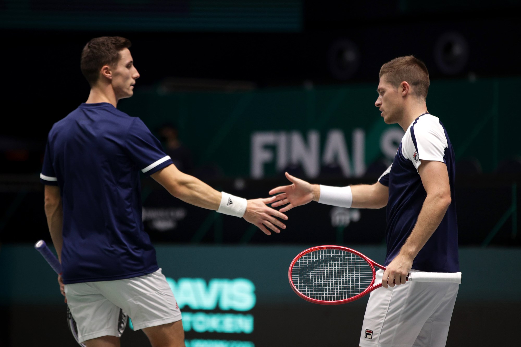 Joe Salisbury and Neal Skupski high five at the 2021 Davis Cup Finals