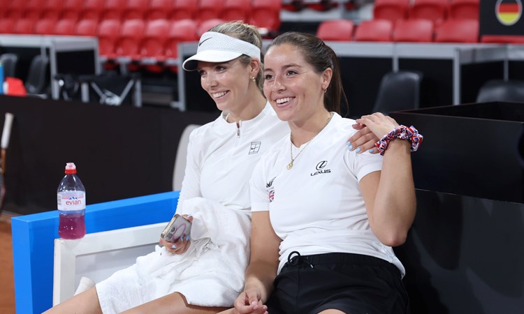 Katie Boulter and Jodie Burrage sat down, smiling and holding hands at the Billie Jean King Cup Qualifiers