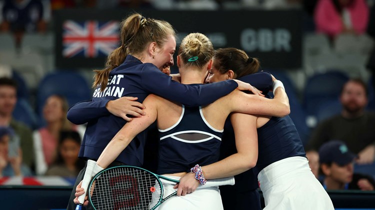 The Great Britain Billie Jean King Cup team hug in celebration after beating Australia