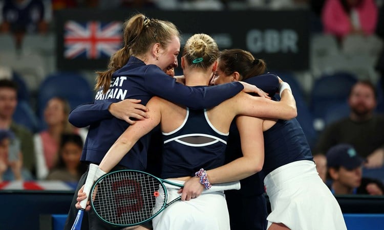 The Great Britain Billie Jean King Cup team hug in celebration after beating Australia