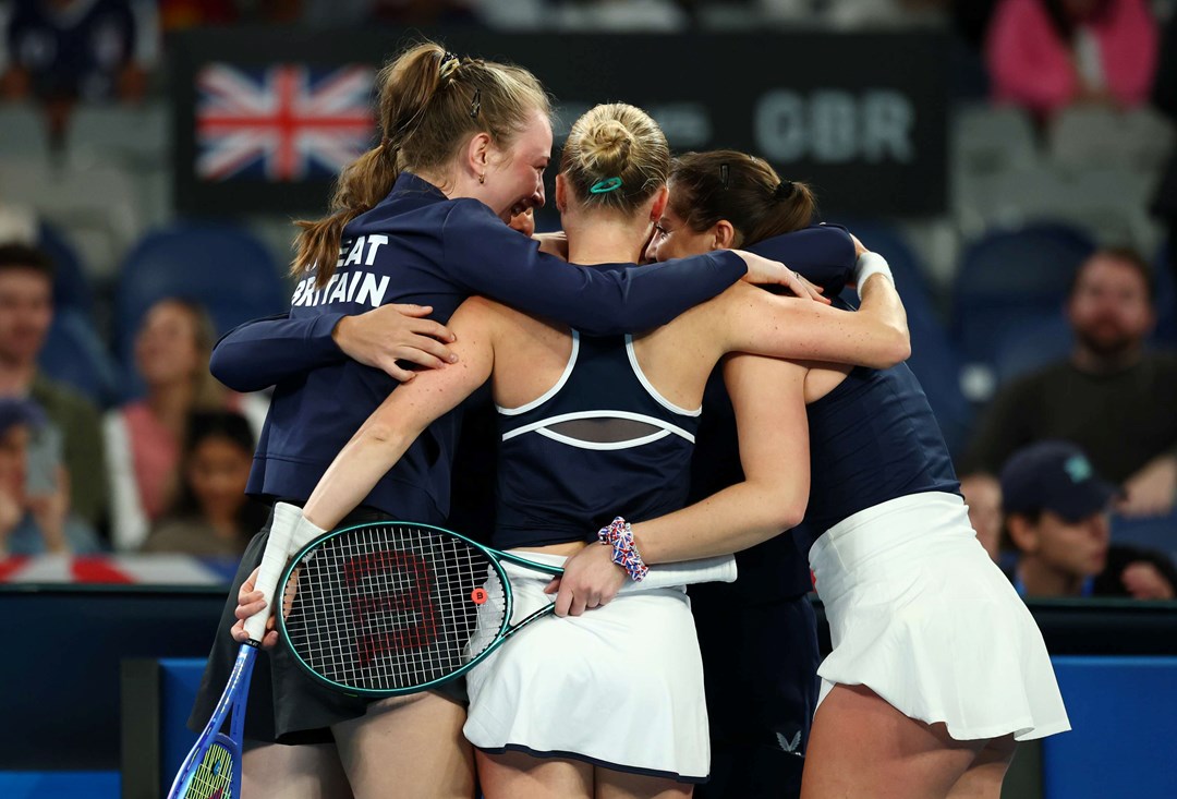 The Great Britain Billie Jean King Cup team hug in celebration after beating Australia
