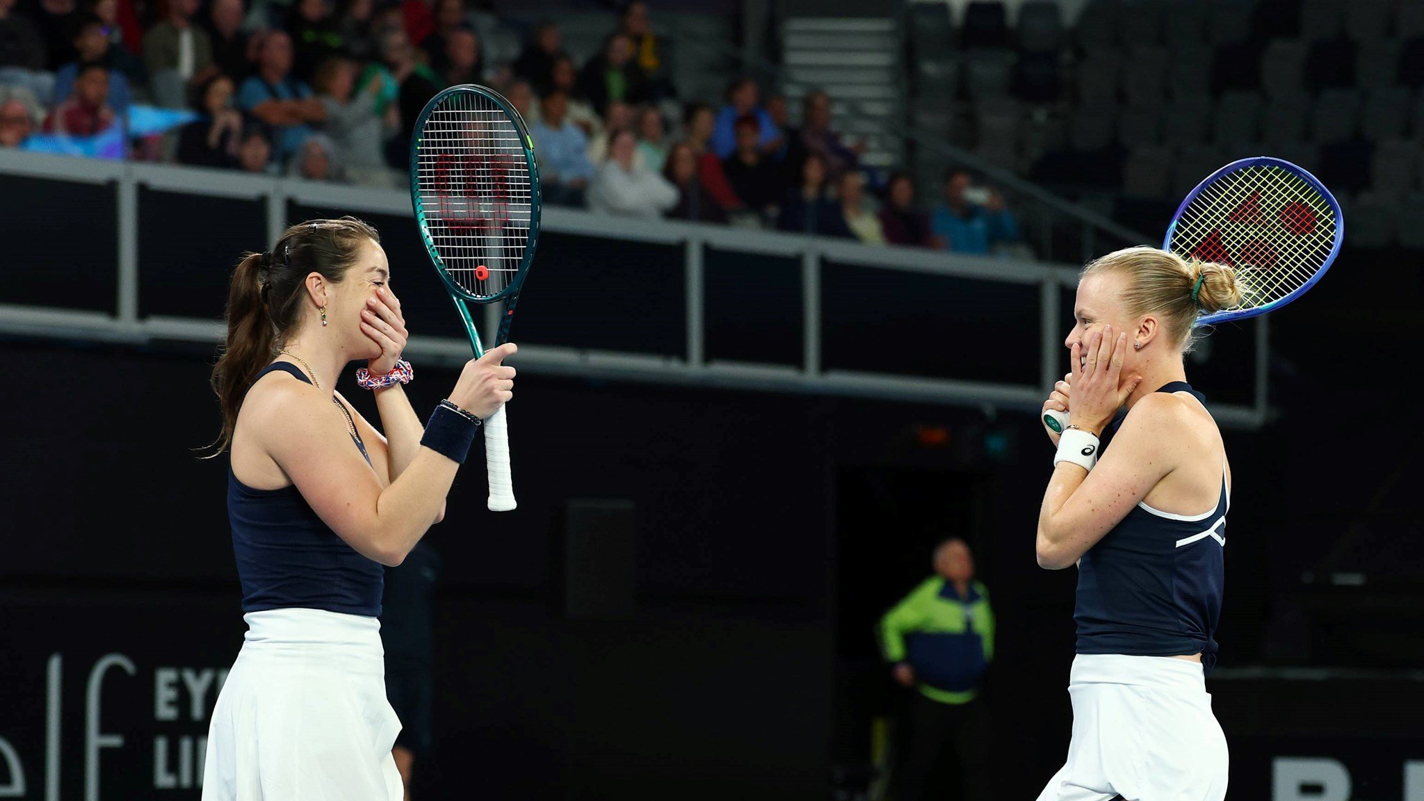 Jodie Burrage and Harriet Dart smile in celebration after beating Australia at Billie Jean King Cup