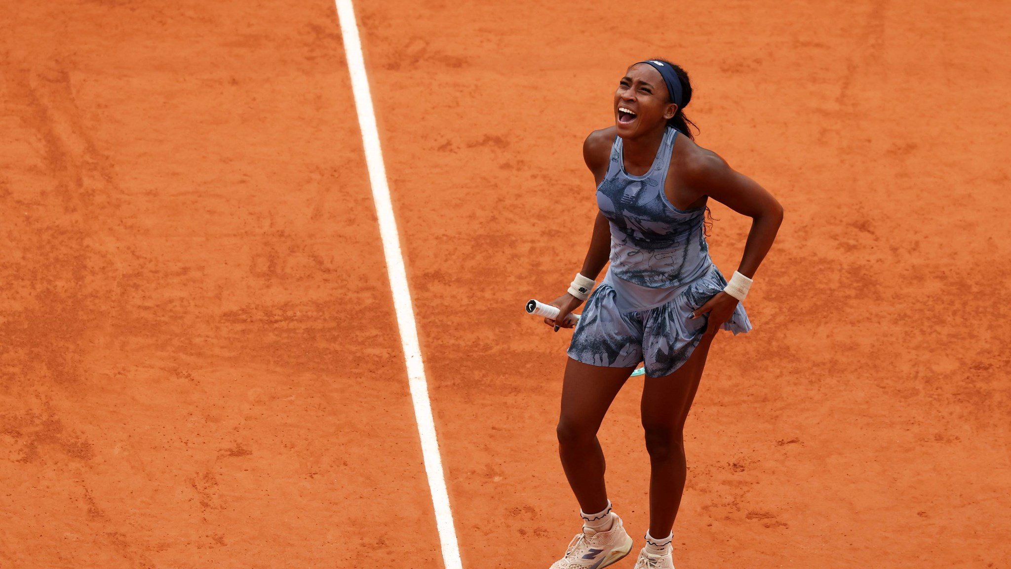 Coco Gauff roars in celebration after winning the Roland Garros title
