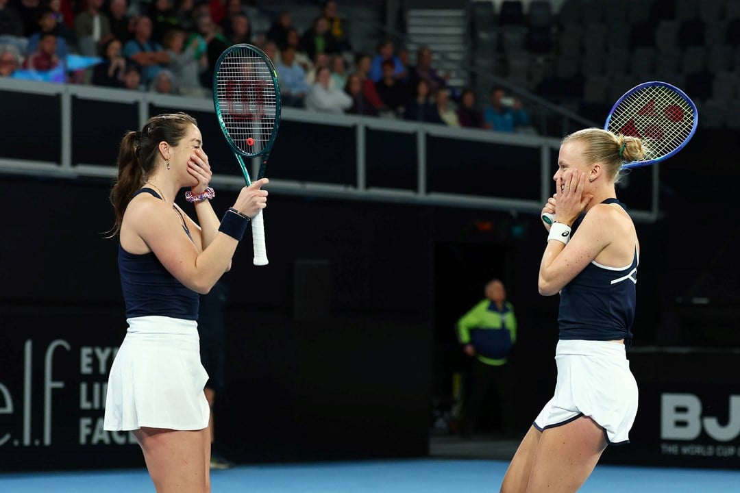 Jodie Burrage and Harriet Dart smile in celebration after beating Australia at Billie Jean King Cup