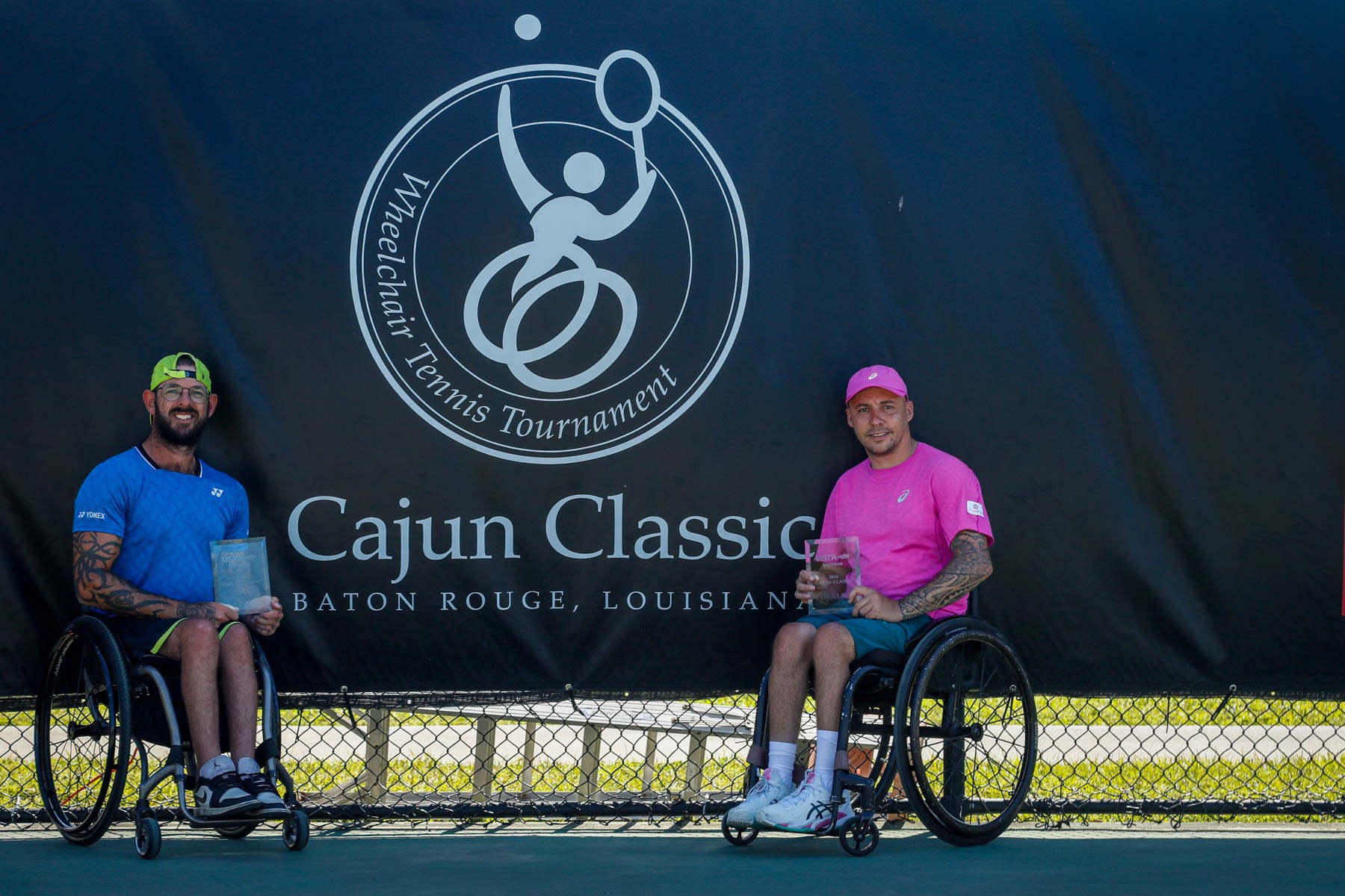 Heath Davidson and Andy Lapthorne holding trophies at the Cajun Classic