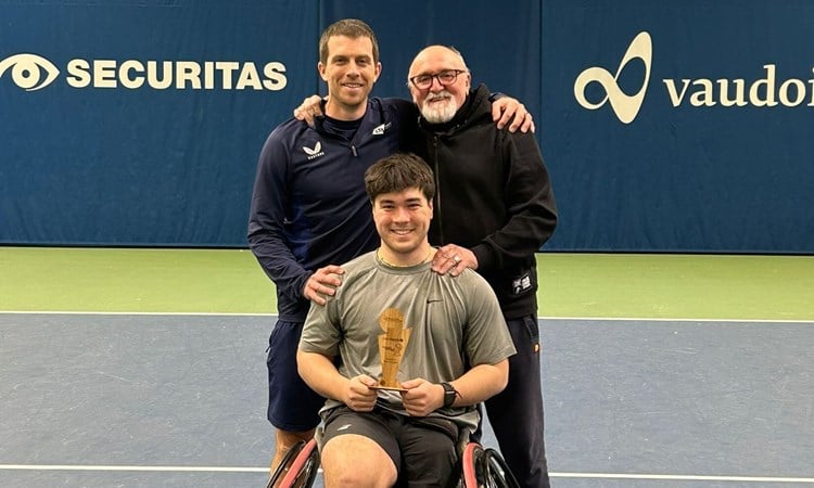 Dahnon Ward holding an ITF Wheelchair Tennis title in Switzerland