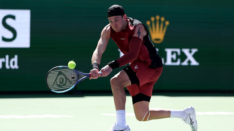 Jack Draper bends down to hit a backhand in the third round of Indian Wells