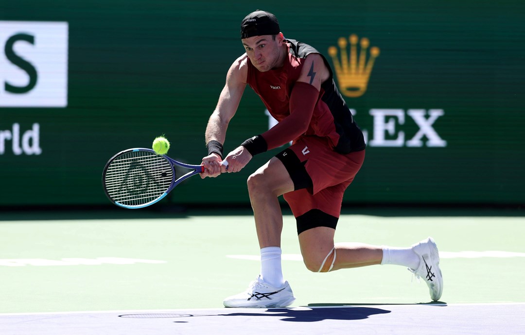 Jack Draper bends down to hit a backhand in the third round of Indian Wells