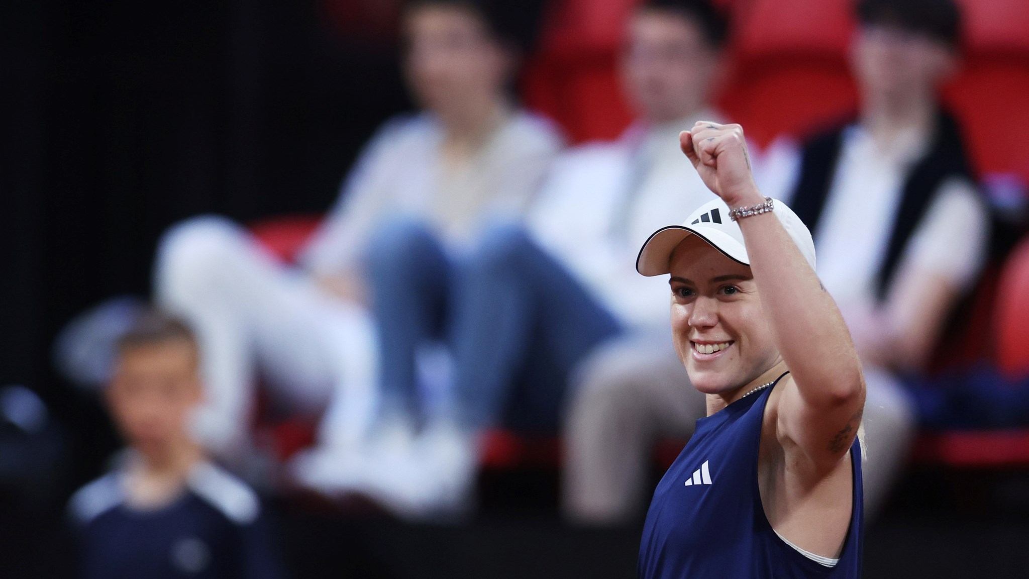 Sonay Kartal raising her arm up in the air and smiling after winning her first match at the Billie Jean King Cup