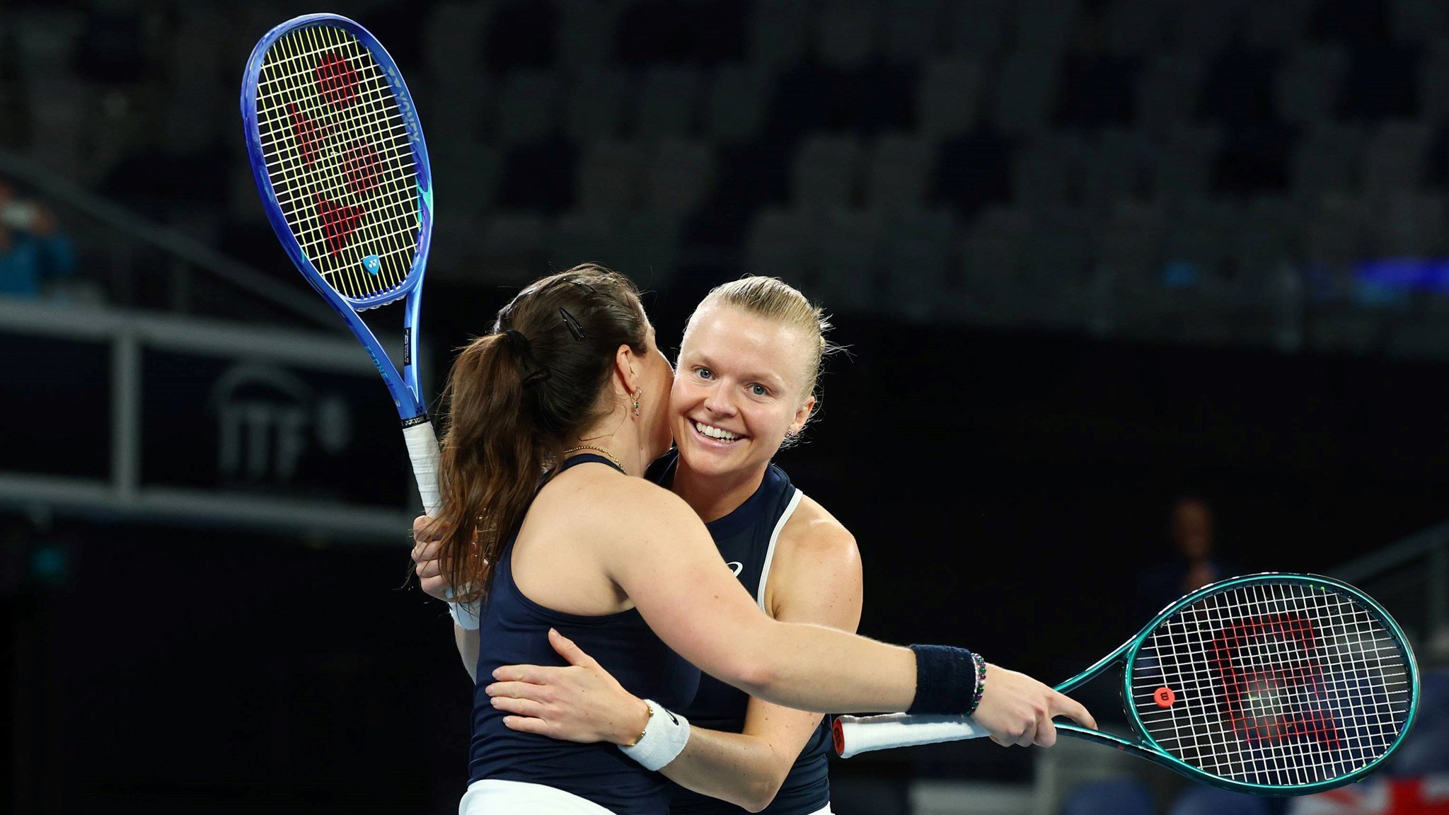 Harriet Dart and Jodie Burrage hug in celebration after beating Australia at the Billie Jean King Cup