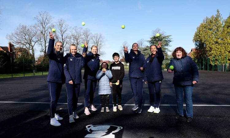 Billie Jean King Cup squad painting a park tennis court at Spencer Park, Coventry