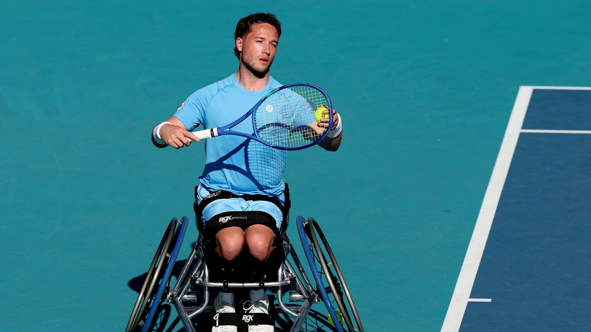 Wheelchair tennis player Alfie Hewett preparing to hit a serve on court at the Miami Open