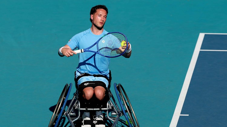 Wheelchair tennis player Alfie Hewett preparing to hit a serve on court at the Miami Open