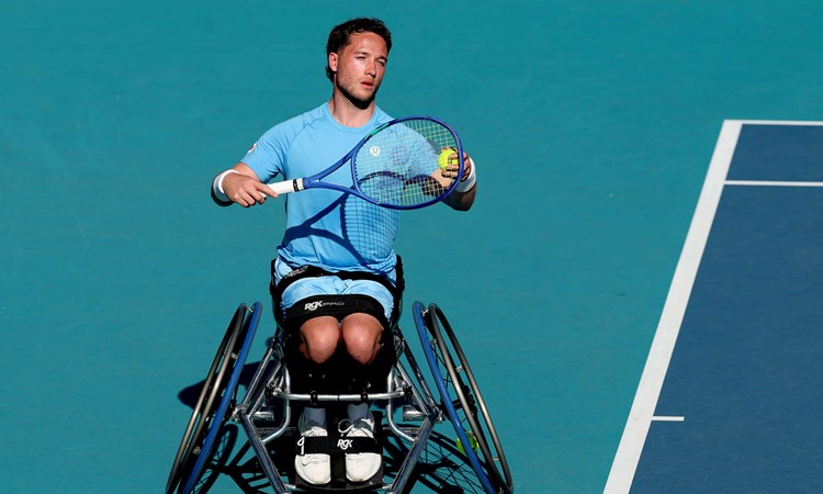 Wheelchair tennis player Alfie Hewett preparing to hit a serve on court at the Miami Open