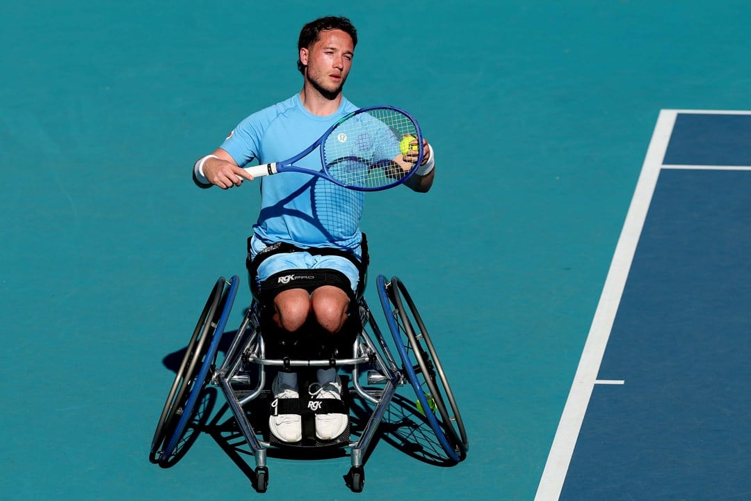 Wheelchair tennis player Alfie Hewett preparing to hit a serve on court at the Miami Open