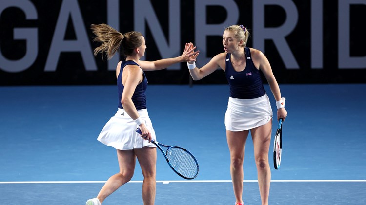 Olivia Nicholls & Alicia Barnett high-fiving on court at the Billie Jean King Cup Qualifiers against France