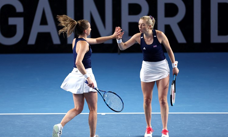 Olivia Nicholls & Alicia Barnett high-fiving on court at the Billie Jean King Cup Qualifiers against France