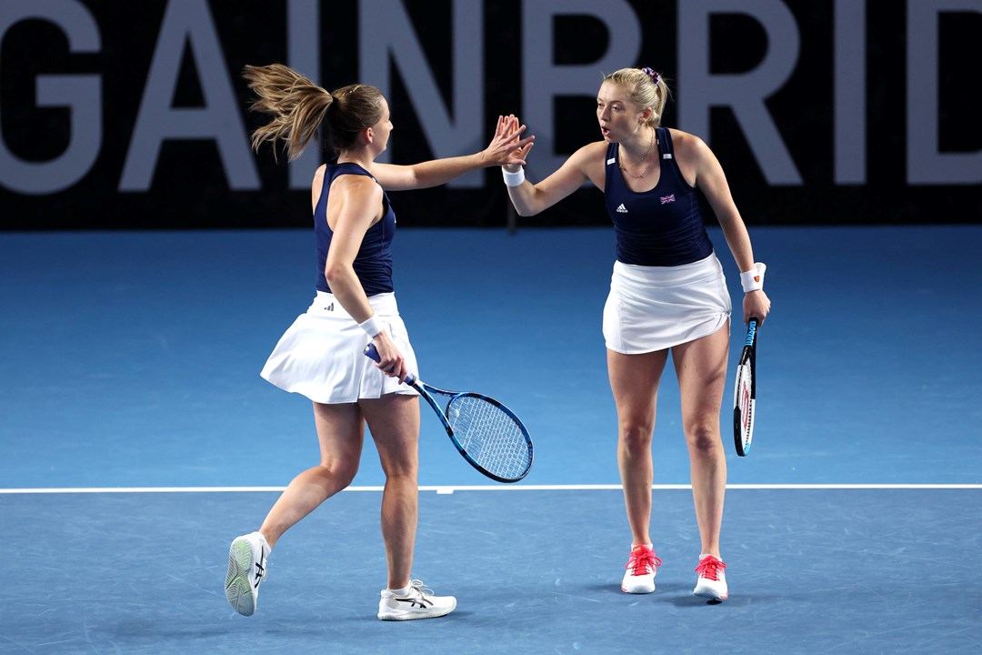 Olivia Nicholls & Alicia Barnett high-fiving on court at the Billie Jean King Cup Qualifiers against France