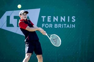 Gusic Man hitting a backhand on court at the Junior National Championships