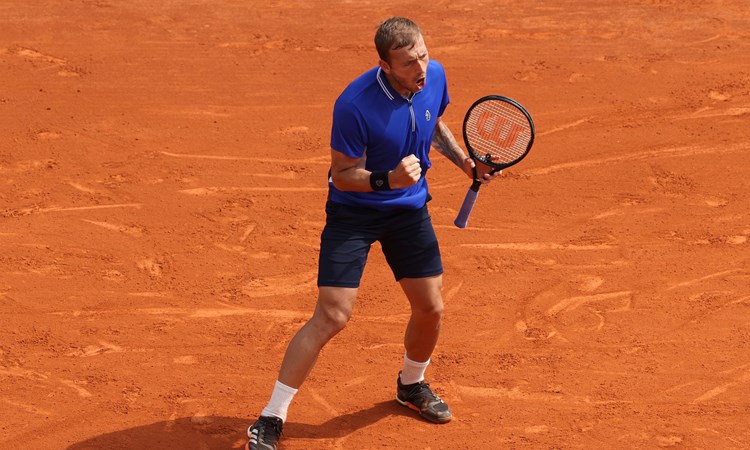 Dan Evans celebrating a win over Novak Djokovic at Monte-Carlo in 2021