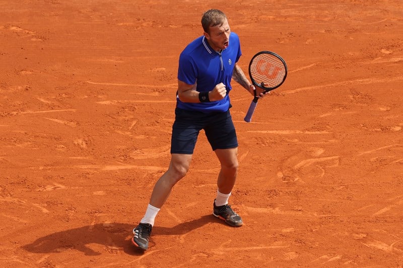 Dan Evans celebrating a win over Novak Djokovic at Monte-Carlo in 2021