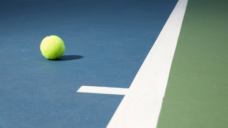 A tennis ball on a court