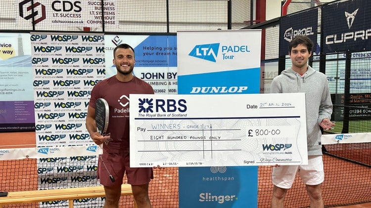 Louie Harris holding a giant cheque after winning the LTA British Tour Padel Stevenson title