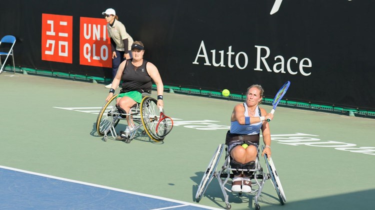 Lucy Shuker lines up a backhand alongside Aniek van Koot at the Japan Open